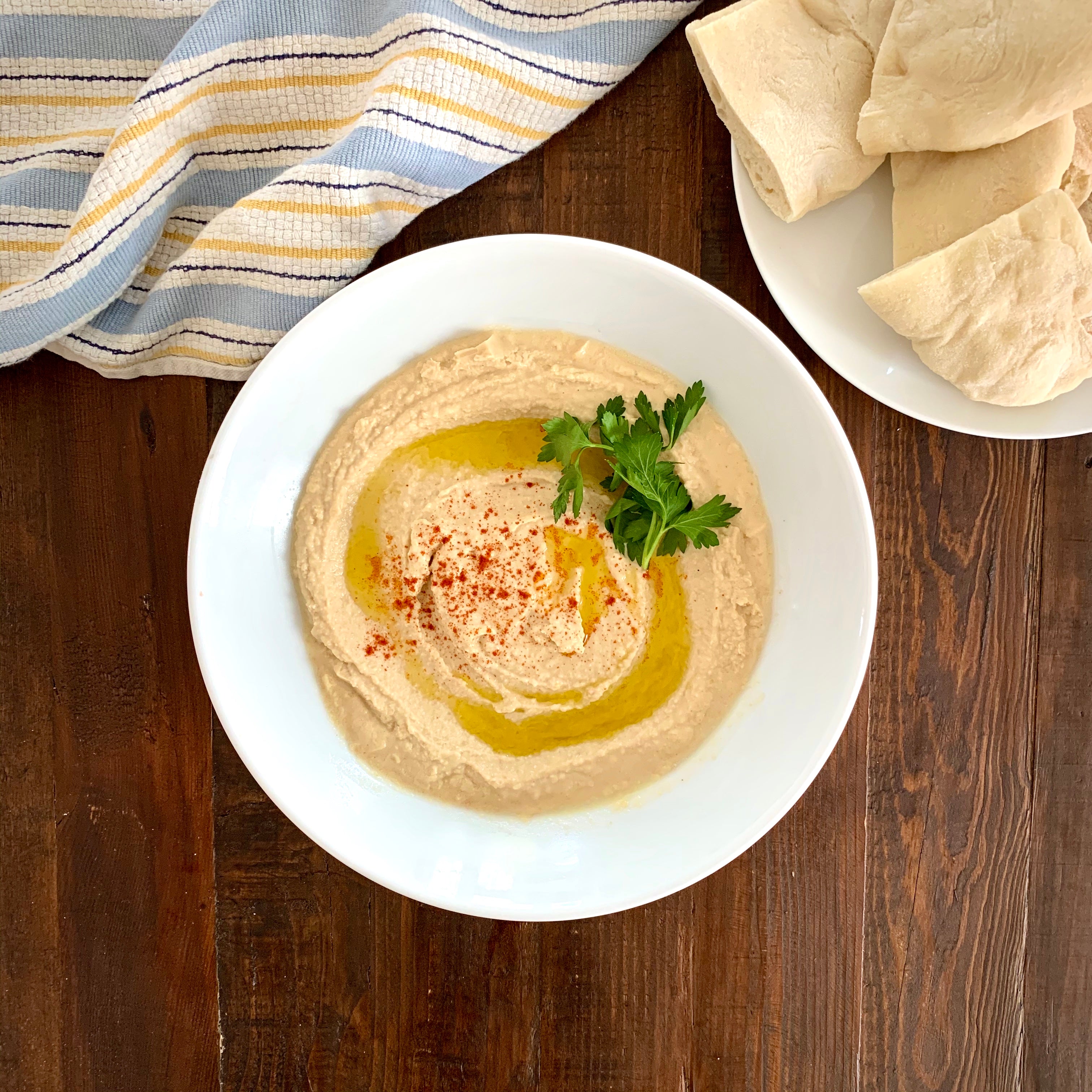 Hummus in plate with pita bread